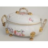 A large early 19th century tureen and cover, floral painted with gilt lion masks and paw feet,