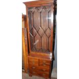 A narrow Georgian style mahogany bookcase with lattice glazed door over a chest with dummy drawers.