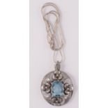 An Arts and Crafts silver blue stone set pendant on silver snake chain.