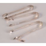 Three pairs of George III bright cut silver sugar tongs.