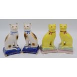 Two pairs of Staffordshire cats, one with yellow glaze, height 10cm,