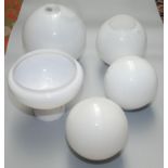 Five opaque glass globular shades, largest height 25cm.