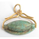 A George III high purity gold seal with snake frame holding an Egyptian revolving turquoise seal.