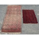 A Belouch rug, with two rows of linked diamond shaped medallions within a serrated leaf border,
