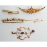 A 9ct gold bar brooch mounted with a pearl set swallow,