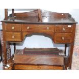 A Victorian mahogany and satinwood crossbanded desk with a drawer above an arch flanked by further