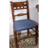 A pair of Victorian dining chairs, each with a horizontal scroll splat and on turned legs.