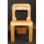 A 1970s style plywood dining chair, the seat downward curving to form a broad central back leg.