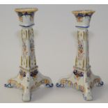 A pair of French faience candlesticks, with floral decoration, height 24cm.