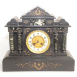 A Victorian black marble mantel clock, the white enamelled dial flanked by twin pillars,