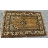 An Afghan rug, the camel mihrab with a pair of pillars flanking a central hanging floral spray,