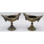 A pair of Regency bronze urns with bearded mask handles on a turned stem and circular base,