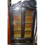 A late Victorian carved ebonised display cabinet.