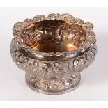 A George IV ornate repousse decorated pedestal silver salt, London 1825. 5oz.