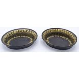 A pair of black lacquered and gilt papier mache pin trays, 10.5 x 8cm.