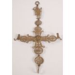 A brass candle holder, the pierced roundels surmounted by a gruesome winged figure, height 70cm.