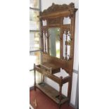 A late Victorian carved oak hall stand.