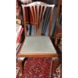 A mahogany dining chair in Georgian style on carved cabriole legs with ball and claw feet.