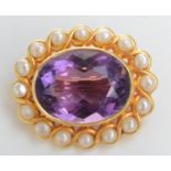 A gold amethyst and pearl oval brooch.