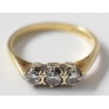 An 18ct gold ring set three diamonds. Condition report: 1.