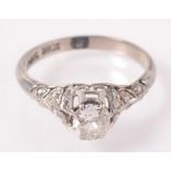 An 18ct white gold and platinum pre war diamond ring with principle cushion cut stone set amongst