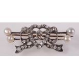 A Victorian heart brooch set diamonds and pearls.