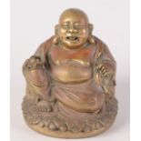 A Chinese bell bronze (brass) figure of Putai seated, smiling and holding a sacred pearl,