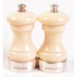 A pair of silver mounted salt and pepper mills simulating ivory.