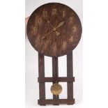 An American Arts and Crafts oak wall clock, diameter of dial 39.5cm, total length 77cm.