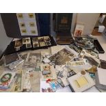 A large collection of postcards, match box tops, empty albums etc.
