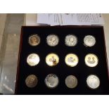 Twelve crown size coins including some silver.