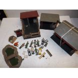 A collection of lead figures, wood buildings etc.