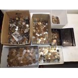A heavy accumulation of world coins in five boxes and a cash tin.