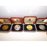 Isle of Man:- Four crowns size silver coins each cased.