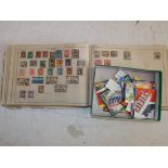 An early bound stamp album containing world stamps and a quantity of British part booklets.