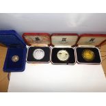 Isle of Man :- A cased silver 50 pence and three other coins.