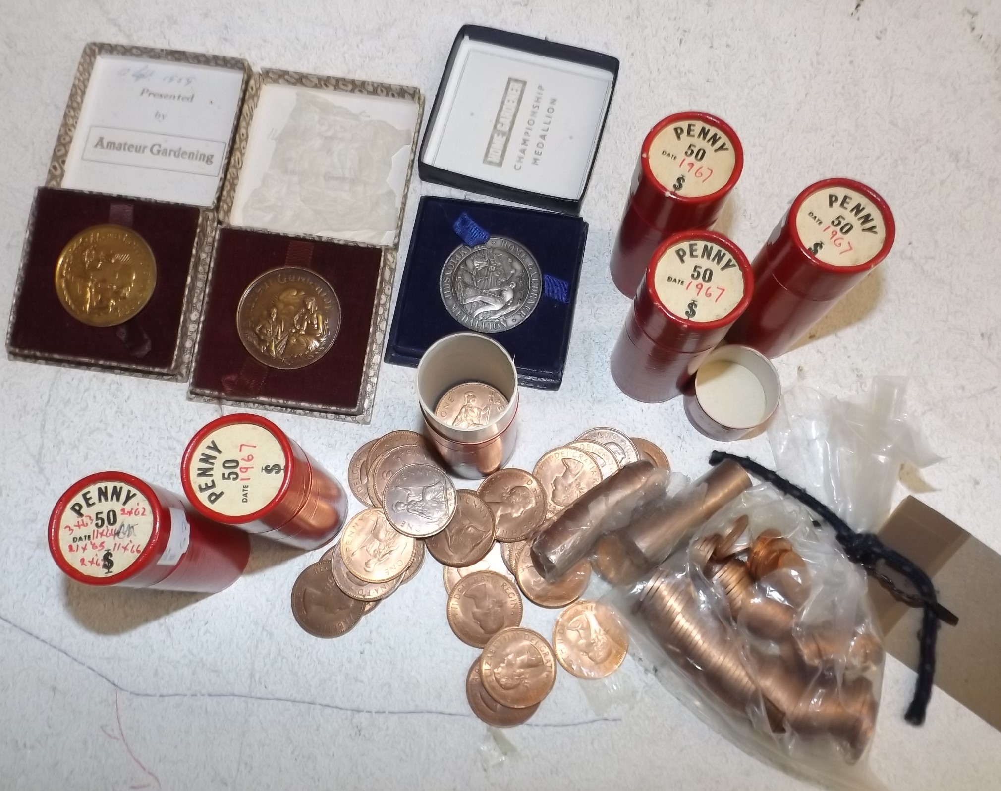 Tube of LSD pennies, new penny and two pennies and gardening medals.