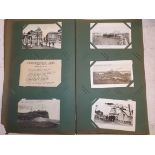 An Edwardian album containing approximately eighty eight postcards, British and foreign including U.