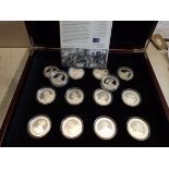 Great Britons:- Fourteen sterling silver crown size coins with eight certificates, wood case.