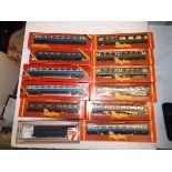 Eleven boxed carriages by Hornby and a boxed Lima wagon.