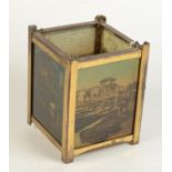 A brass hall lantern, with four photographic glass panels showing coastal and river scenes,