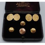 A pair of late Victorian ivy leaf chased 9ct gold cuff links in a dress set case with three