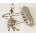An eastern silver coloured metal Quranic vessel and a nomadic silver coloured metal pin and pendant.