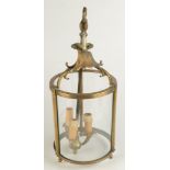 A George III style cylindrical brass hall lantern, with three glazed panels, total height 48cm.