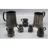 Two pewter tankards and five measures, height of largest 12.5cm.