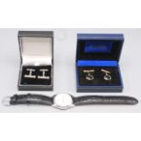 A pair of silver post-war cufflinks, each gold mounted and set with black onyx cabouchons,