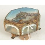 A gilt metal and glass jewel box, the cover decorated with 'Mont St Michel', height 6.5cm, width 12.