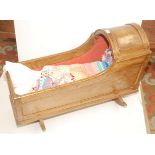 A wooden rocking crib with later staining, length 37".