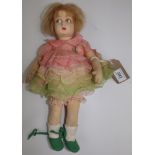 A Lenci fabric doll, pressed felt head with painted features on a felt and cloth body, arms,