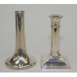 Two modern filled silver candlesticks one of trumpet form the other with square base.